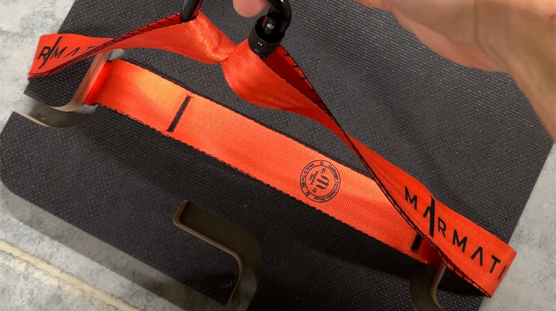 Orange LINK™ suspension strap routed through the STAGE™ platform slots and connected with a carabiner